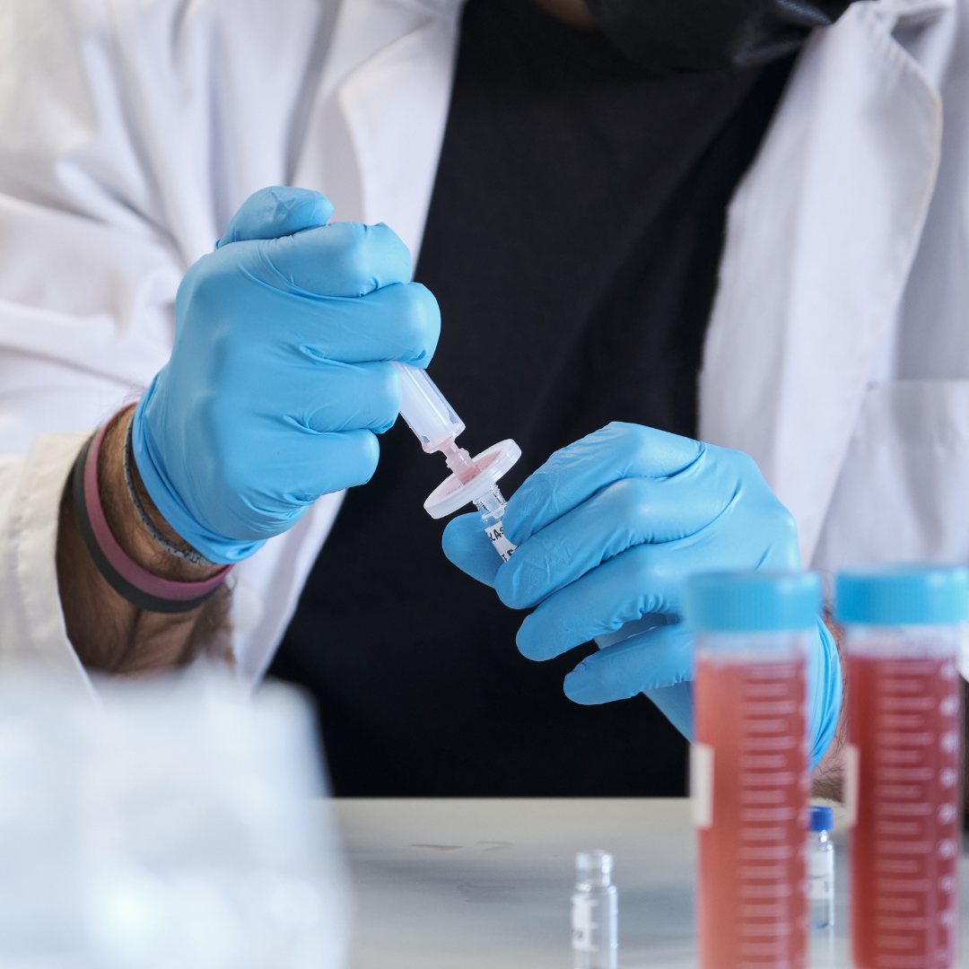 Lab technician pipetting sample into wide opening vial